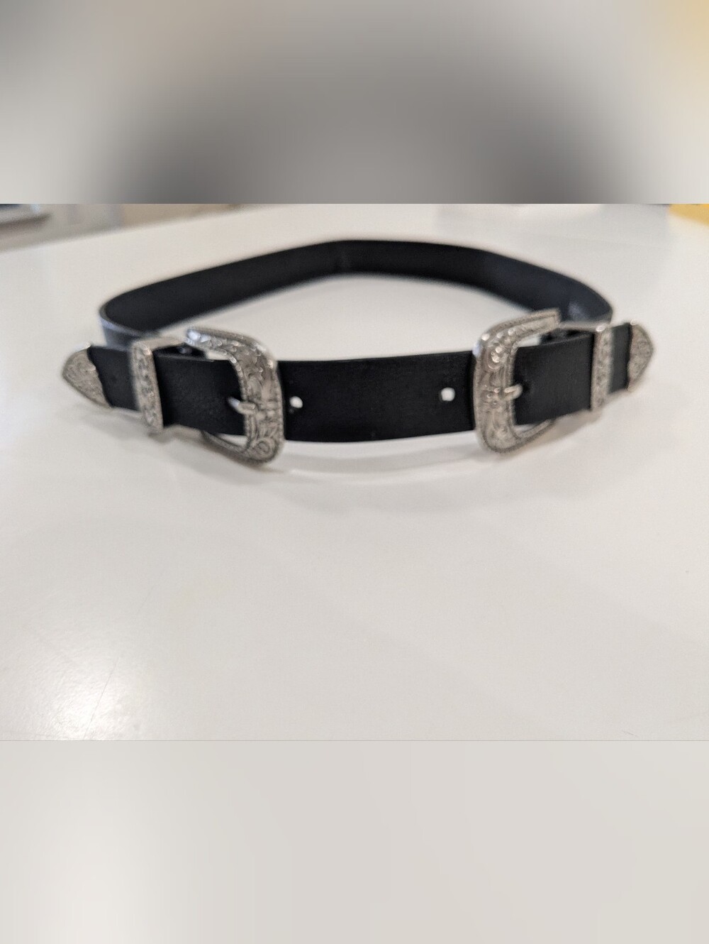 Black Western double-buckle belt with  silver-tone floral/filigree hardware